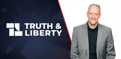 The Truth & Liberty logo beside a presenter in front of the United States flag